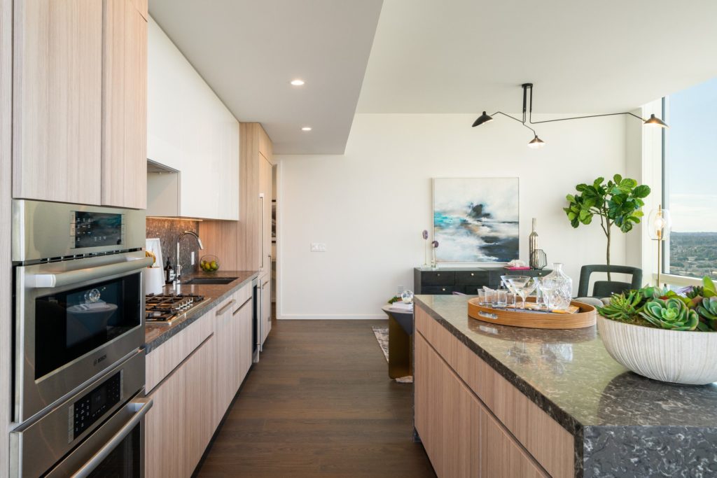 Downtown Los Angeles Residences - THEA at Metropolis Open Kitchen with Island, Stainless Steel Appliances, and High-End Finishes