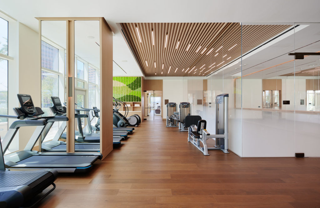 Luxury Residences in Downtown Los Angeles CA - State-of-the-Art Fitness Center with Stylish Interiors and Various Gym Equipment