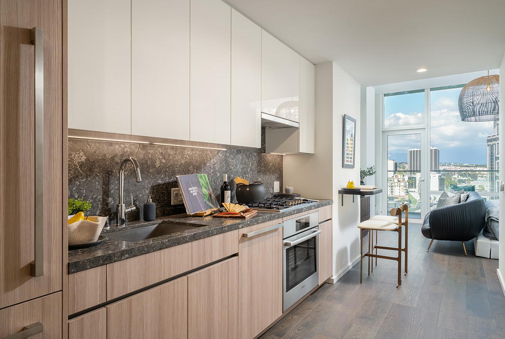 Residences for Rent in Downtown Los Angeles CA - THEA at Metropolis - Modern Kitchen with Black Marble Countertops, Designer Cabinets, and Wood Flooring
